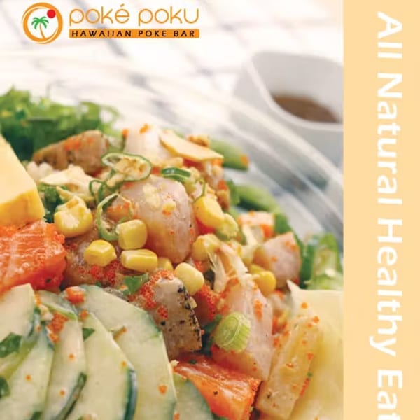 Close-up of a vibrant Poke Poku poke bowl with fish, corn, cucumbers, and roe.