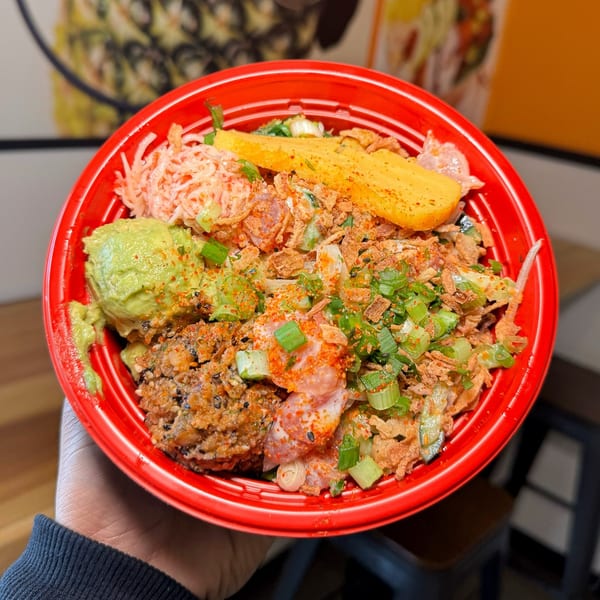 A vibrant Poke Poku bowl filled with fresh ingredients, including avocado, mango, and various toppings.